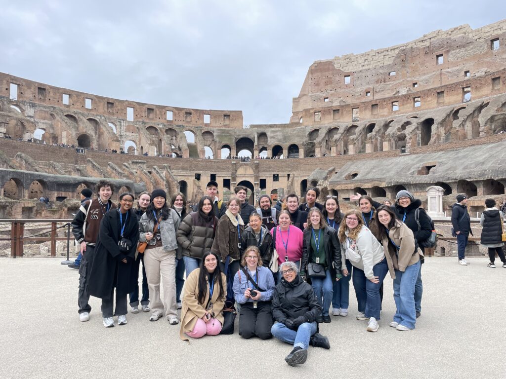 UW students and two professors stop for a quick group photo while touring the Colosseum in Rome.